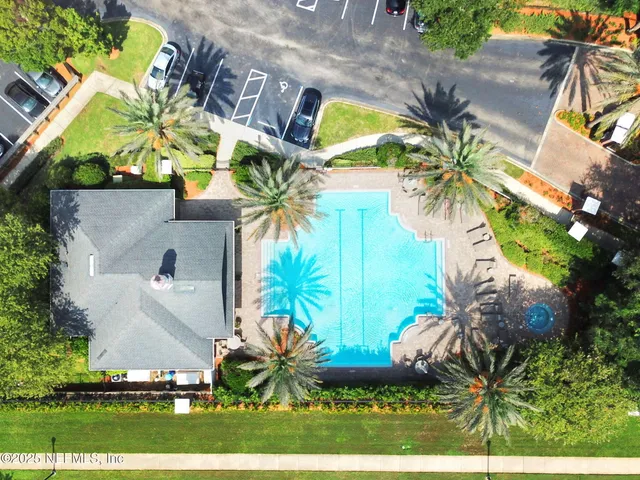 an aerial view of residential houses with outdoor space and swimming pool