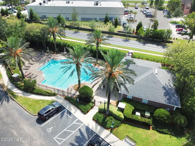 an aerial view of a house with garden space and street view