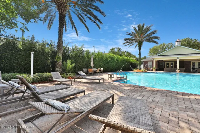 a view of a house with swimming pool and furniture