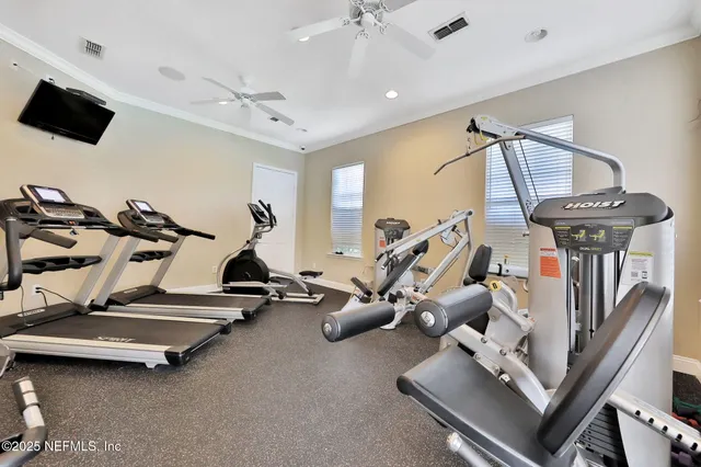 a room with gym equipment and a flat screen tv