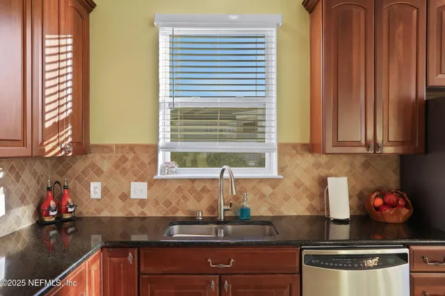 a kitchen with granite countertop cabinets and window