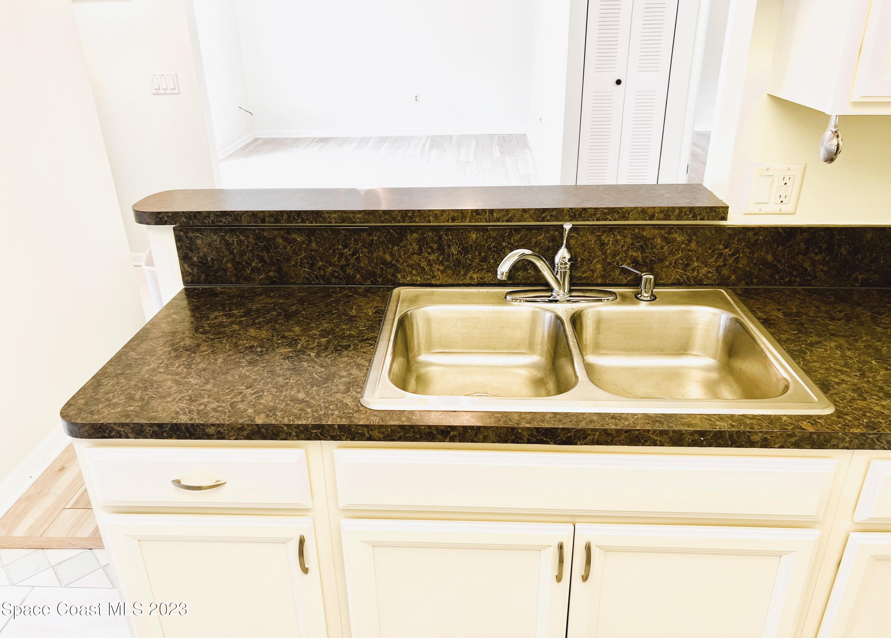 756 Ridge Club Drive, Unit 61 Melbourne, FL 32934 - Photo 14 of 29 a close view of sink and tap