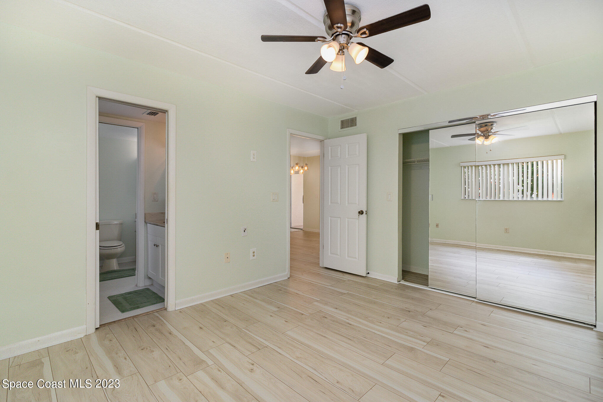 756 Ridge Club Drive, Unit 61 Melbourne, FL 32934 - Photo 15 of 29 a view of empty room with wooden floor and fan