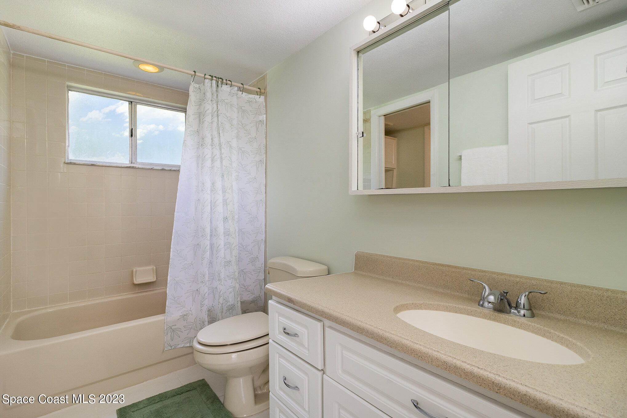 756 Ridge Club Drive, Unit 61 Melbourne, FL 32934 - Photo 18 of 29 a bathroom with a granite countertop sink toilet and shower