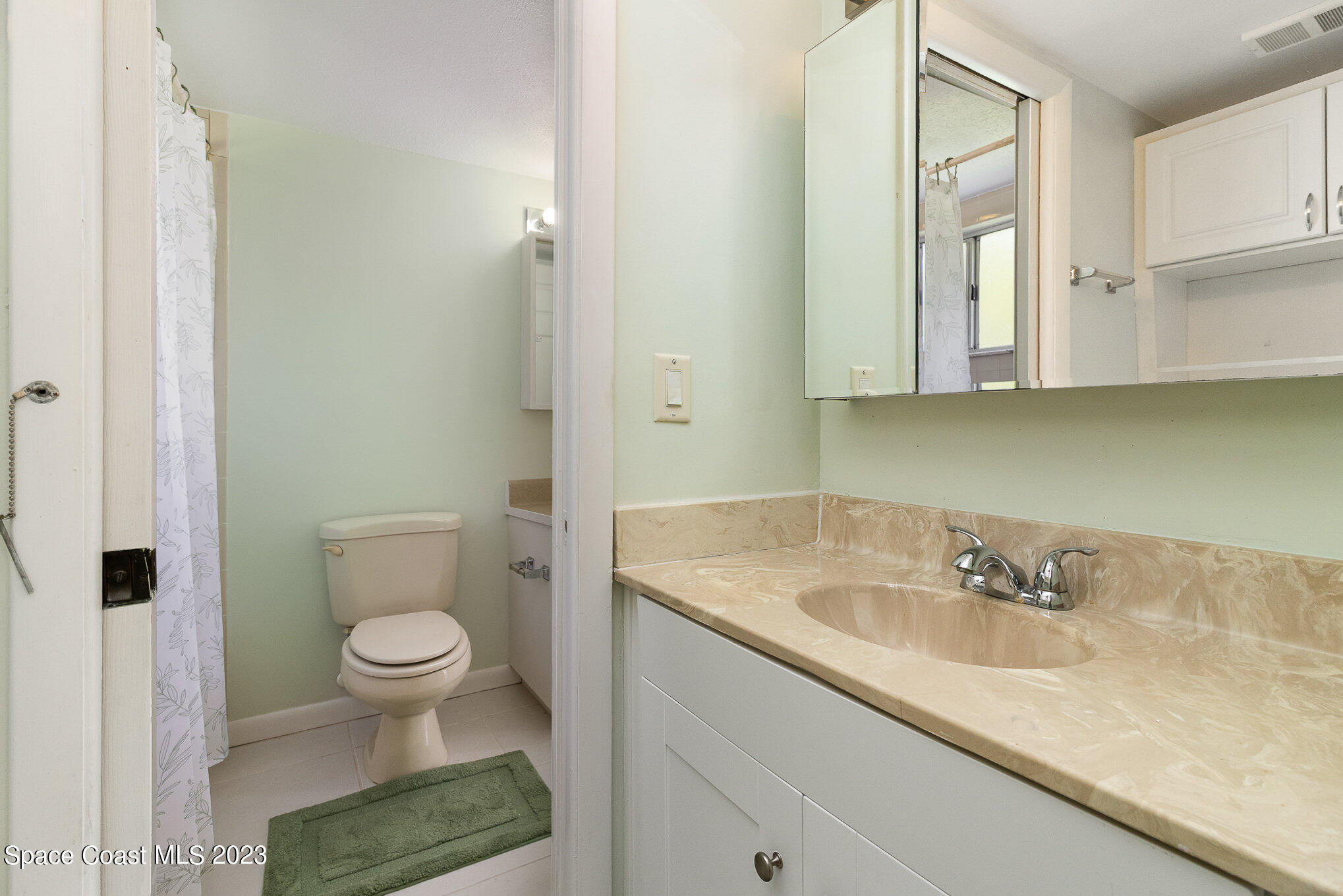 756 Ridge Club Drive, Unit 61 Melbourne, FL 32934 - Photo 19 of 29 a bathroom with a sink and a mirror