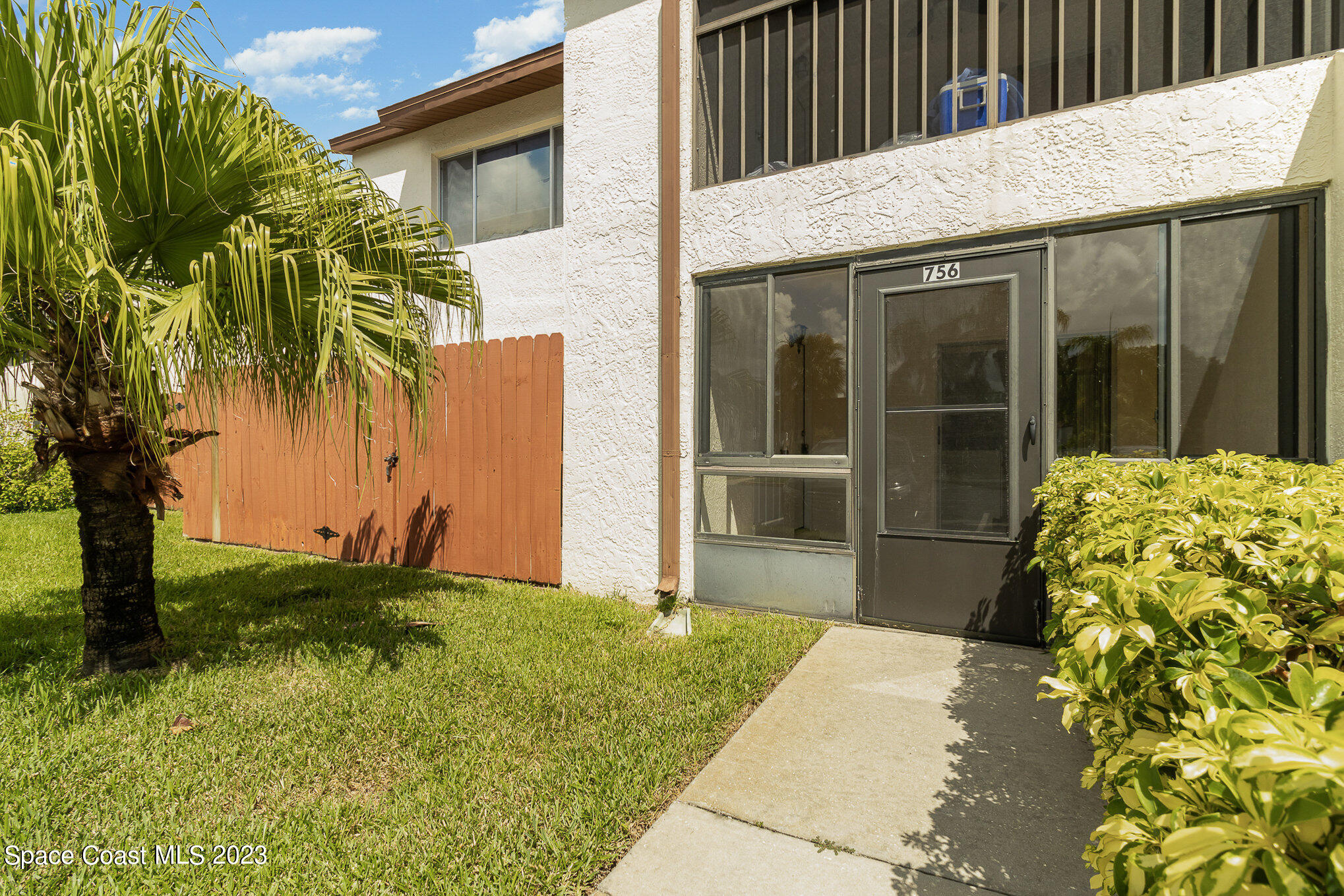 756 Ridge Club Drive, Unit 61 Melbourne, FL 32934 - Photo 2 of 29 a front view of a house having yard