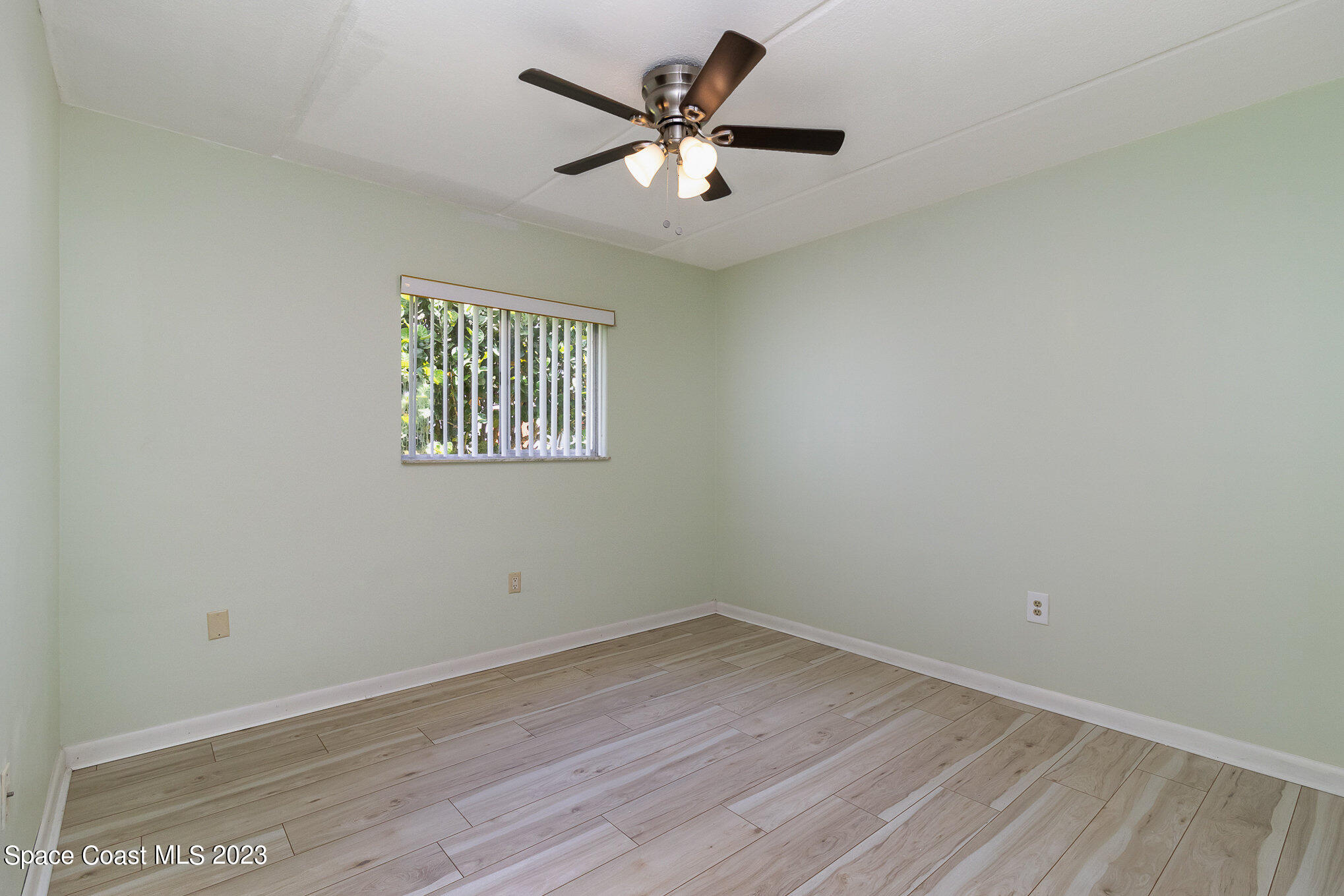 756 Ridge Club Drive, Unit 61 Melbourne, FL 32934 - Photo 21 of 29 an empty room with a window and a ceiling fan