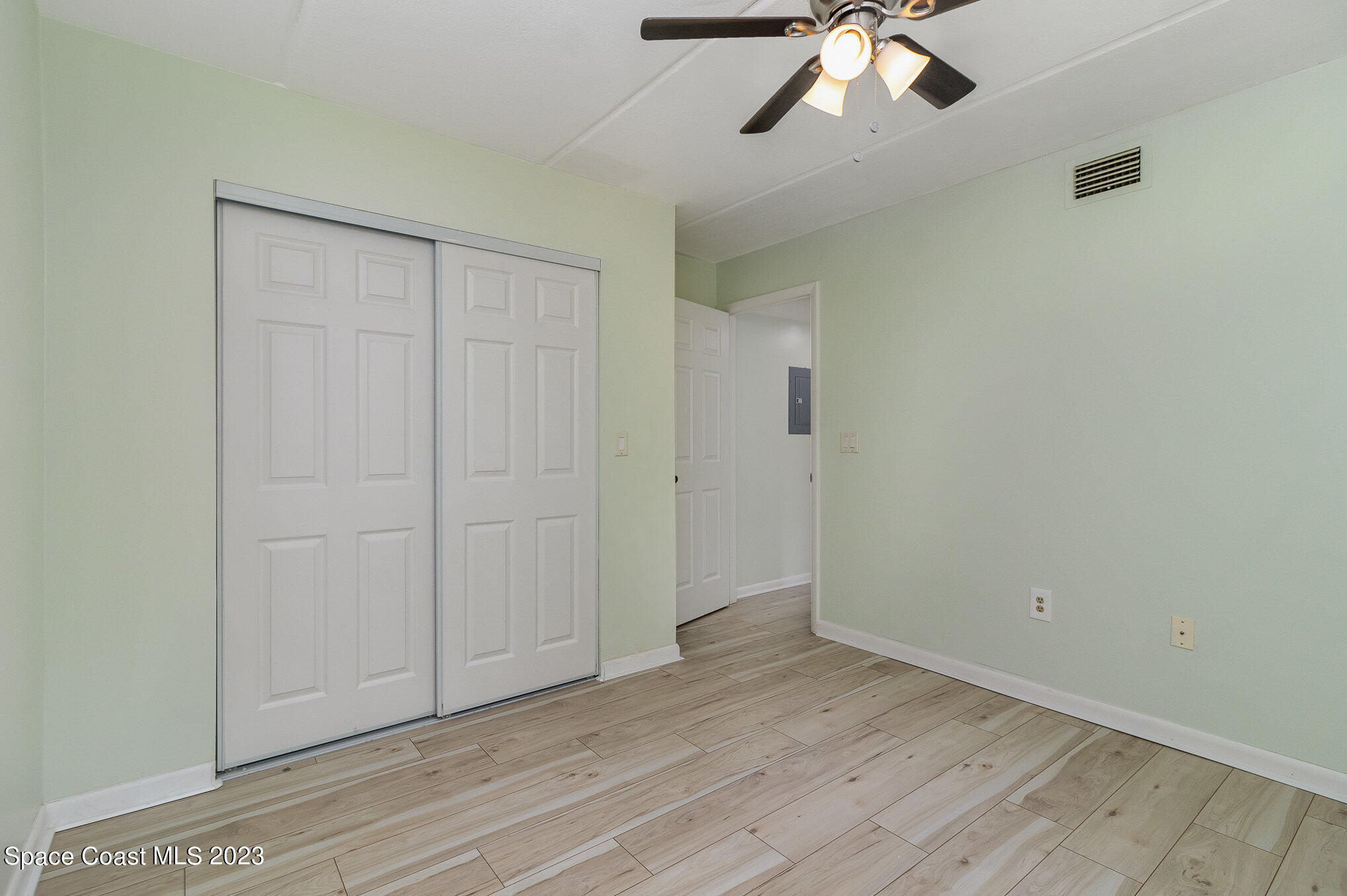 756 Ridge Club Drive, Unit 61 Melbourne, FL 32934 - Photo 22 of 29 wooden floor in an empty room