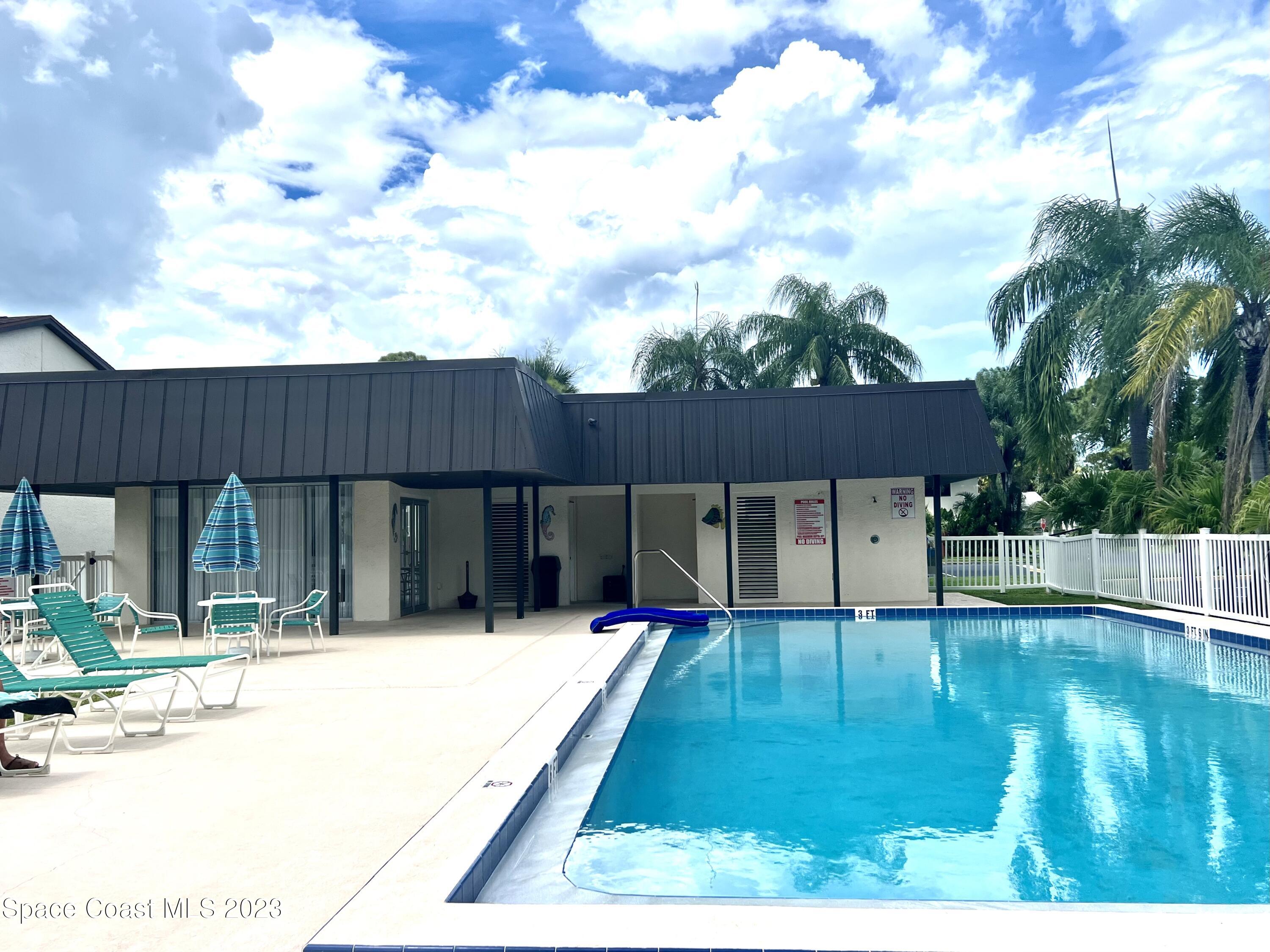 756 Ridge Club Drive, Unit 61 Melbourne, FL 32934 - Photo 26 of 29 a swimming pool with outdoor seating and yard