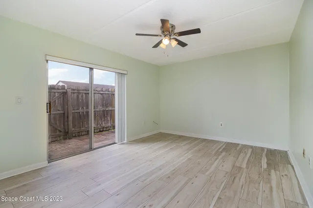 a view of a kitchen with wooden floor and a ceiling fan