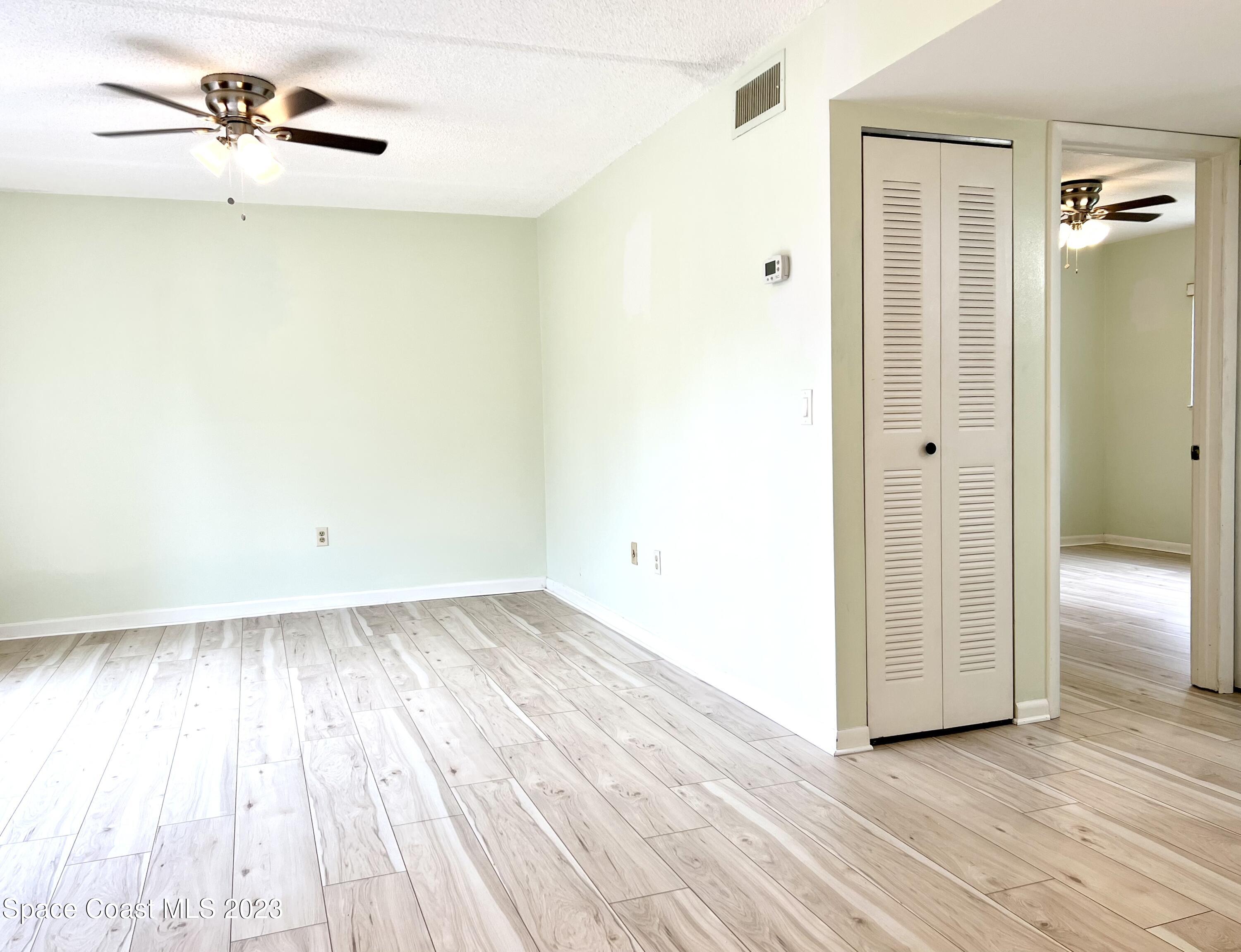 756 Ridge Club Drive, Unit 61 Melbourne, FL 32934 - Photo 8 of 29 wooden floor in an empty room