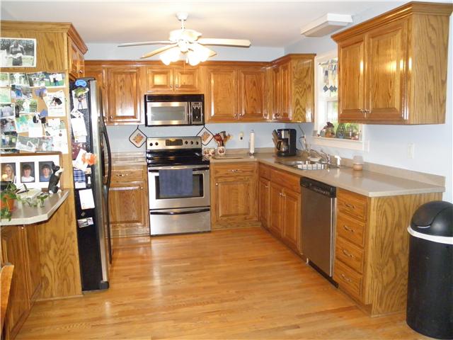 603 Brown Road Bon Aqua, TN 37025 - Photo 5 of 20 Kitchen w/oak cabinetry, corian counter tops, stainless steel appliances...range, dishwasher, microwave.