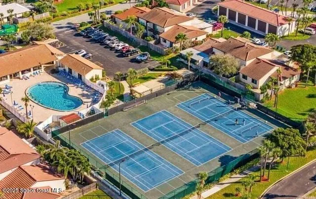 an aerial view of residential houses with outdoor space