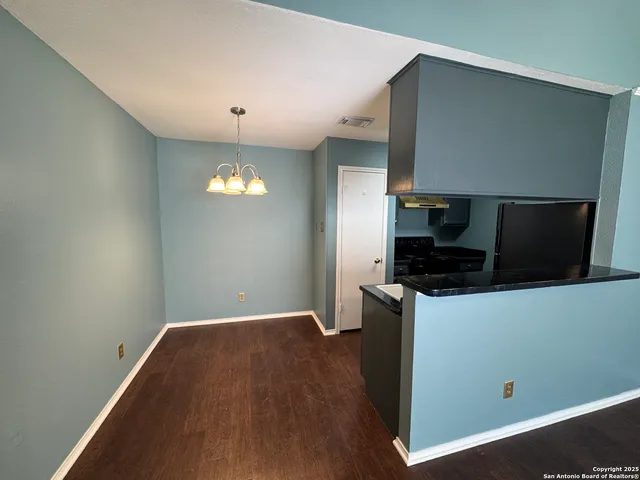 a kitchen with a refrigerator and a stove top oven