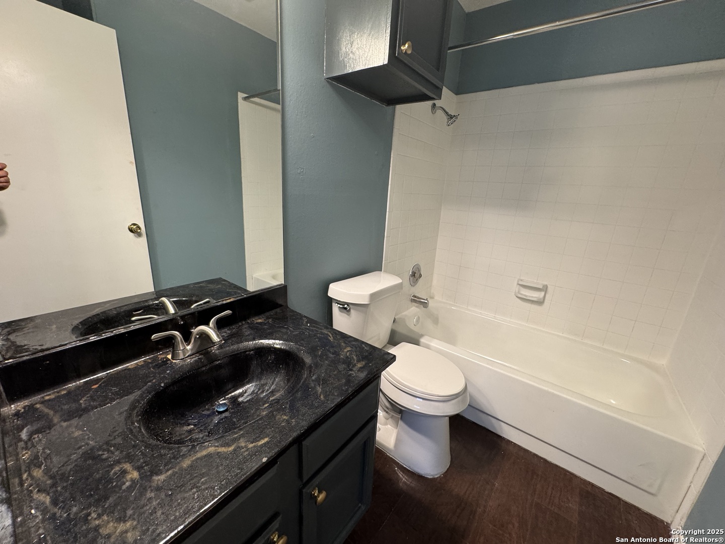 4803 Hamilton Wolfe Road, Unit 606 San Antonio, TX 78229 - Photo 8 of 9 a bathroom with a sink a toilet and shower