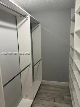 14218 Southwest 176th Terrace Miami, FL 33177 - Photo 11 of 19 a view of closet area with wooden floor