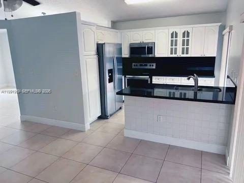 14218 Southwest 176th Terrace Miami, FL 33177 - Photo 14 of 19 a kitchen with stainless steel appliances a refrigerator and a sink