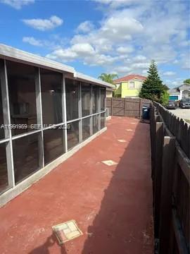 14218 Southwest 176th Terrace Miami, FL 33177 - Photo 18 of 19 a view of roof deck with wooden floor and fence
