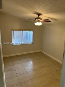 14218 Southwest 176th Terrace Miami, FL 33177 - Photo 10 of 19 a view of a room with a ceiling fan and a rug