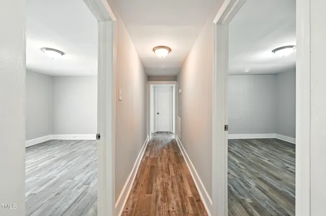 a view of hallway with wooden floor