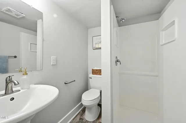 a bathroom with a sink toilet and shower