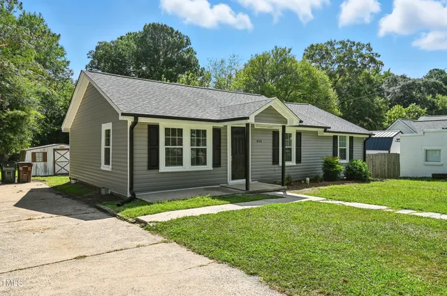 a front view of a house with a yard