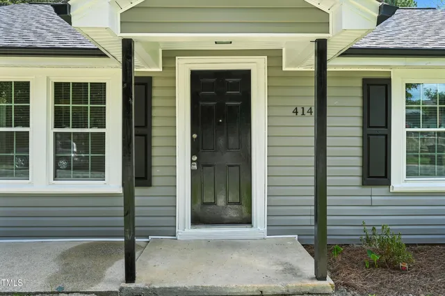 a front view of a house with a glass door and a window