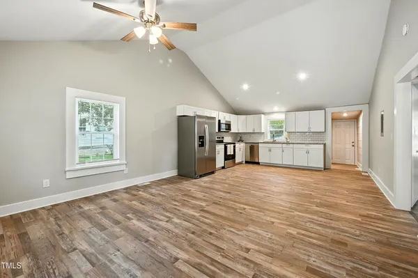 a view of a kitchen with a microwave and refrigerator