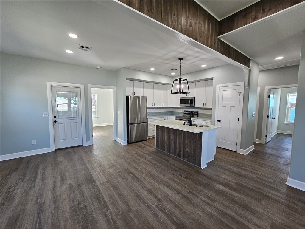 2366 Scott Circle Ingleside, TX 78362 - Photo 11 of 26 a kitchen with stainless steel appliances kitchen island granite countertop a refrigerator and a stove