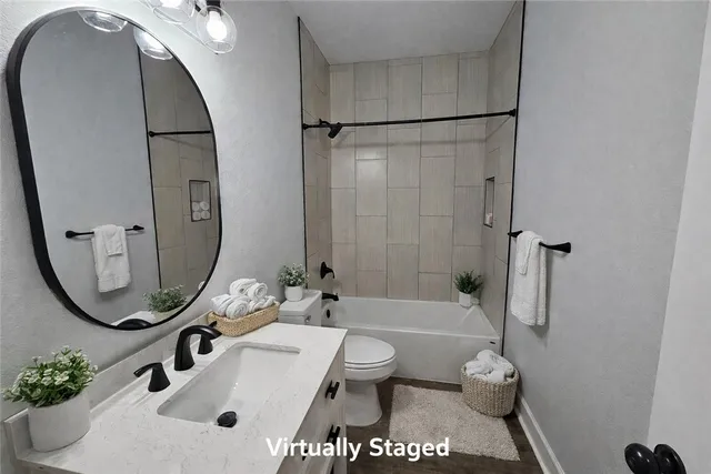 a bathroom with a sink a toilet and a mirror
