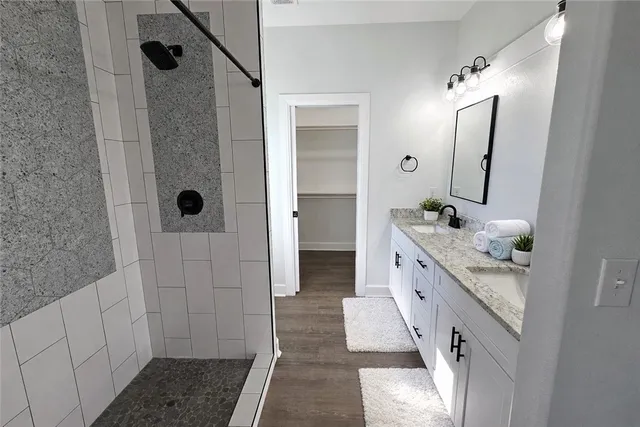 a bathroom with a double vanity sink and mirror