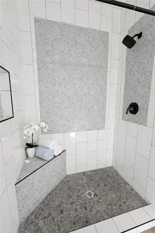 a bathroom with a granite countertop sink a toilet and shower