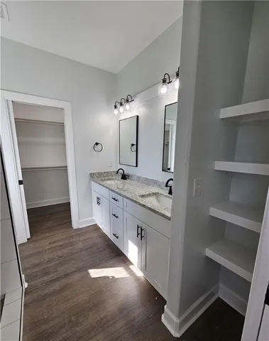 a large bathroom with a double vanity sink and a mirror