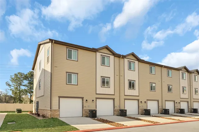 a front view of a building with a garden