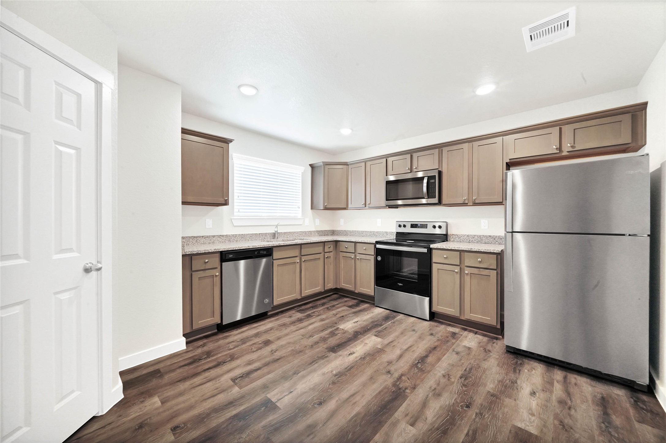 12603 Telge Road, Unit 22EF Cypress, TX 77429 - Photo 4 of 20 a kitchen with a refrigerator a stove top oven a sink and dishwasher