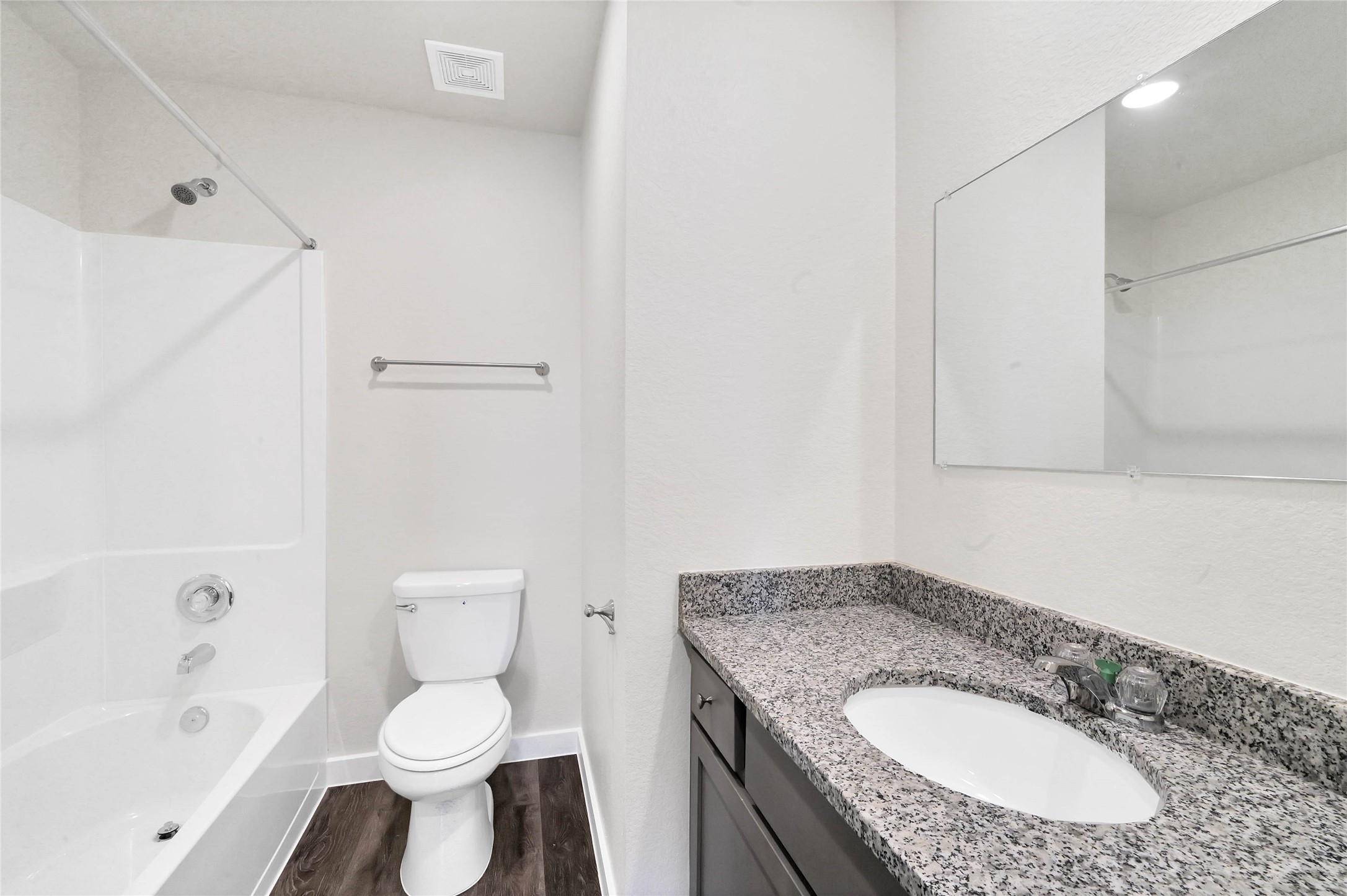 12603 Telge Road, Unit 22EF Cypress, TX 77429 - Photo 9 of 20 a bathroom with a granite countertop sink toilet a mirror and bathtub