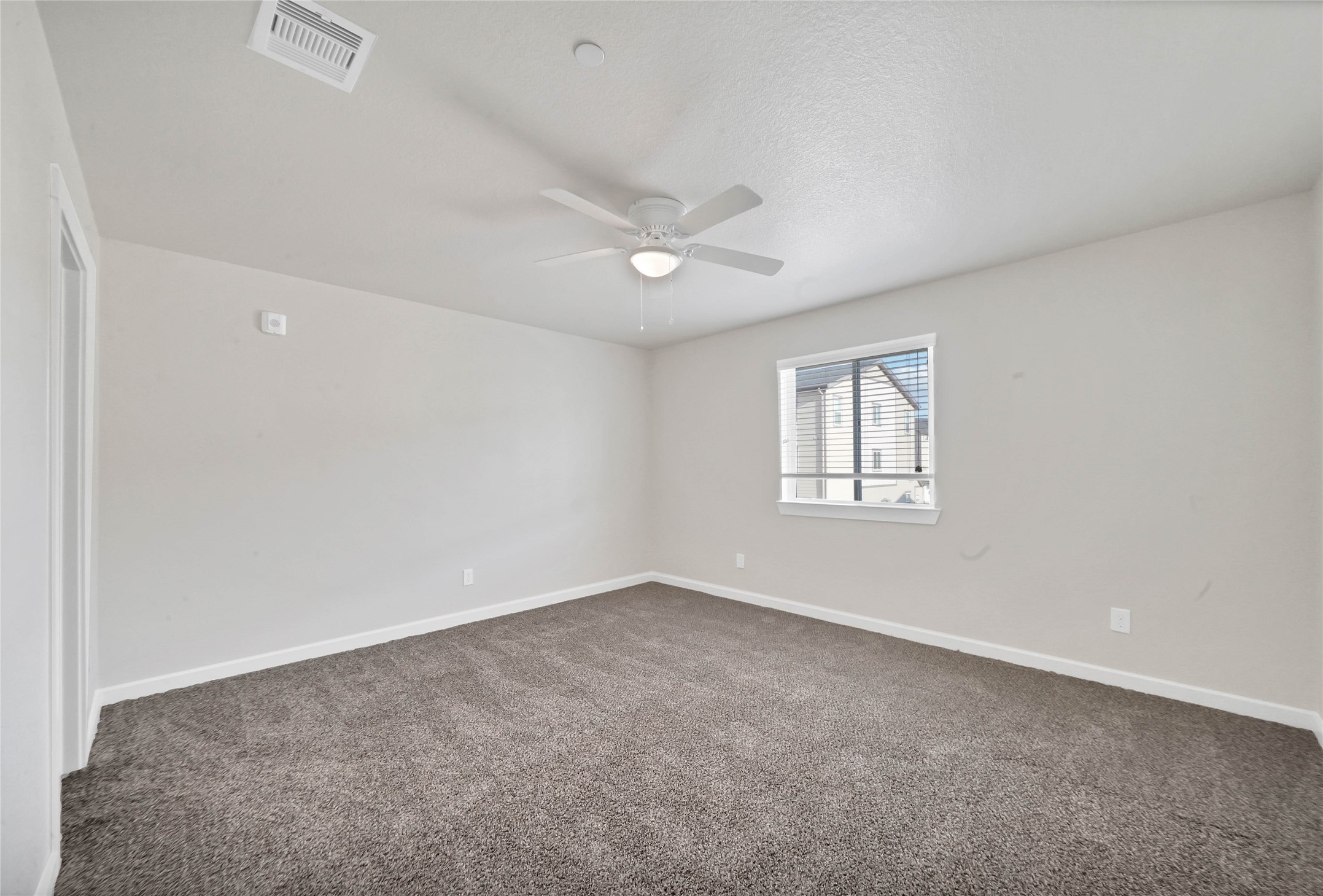 12603 Telge Road, Unit 22EF Cypress, TX 77429 - Photo 10 of 20 an empty room with a ceiling fan and a window