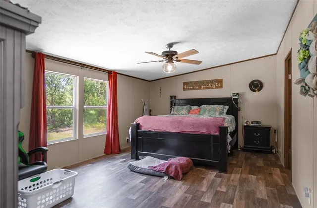 a bedroom with a bed and a mirror on the dresser