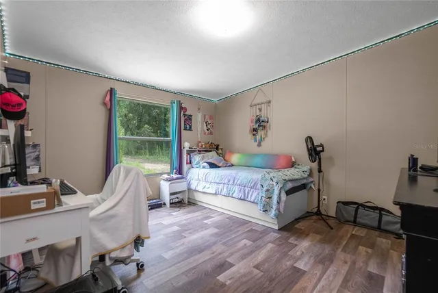 a room with a bed and a television