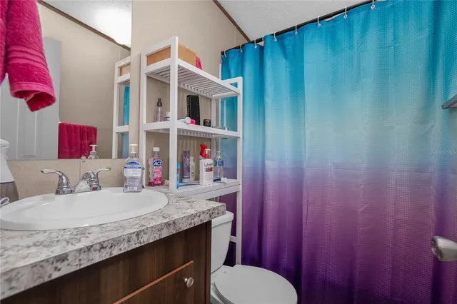 a room with furniture a flat screen tv and a window