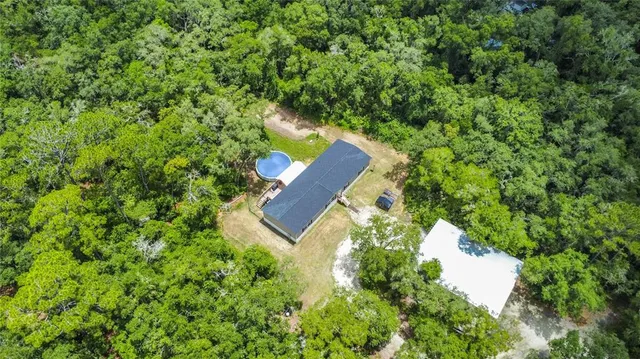 an aerial view of a house with garden space and street view