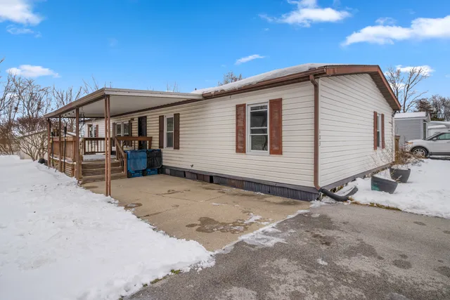 a view of a house with a wooden fence
