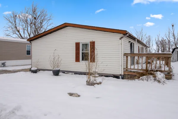 a backyard of a house with fire pit and chairs
