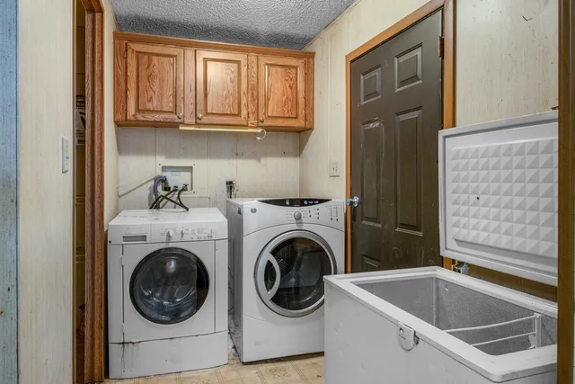 a utility room with sink dryer and washer