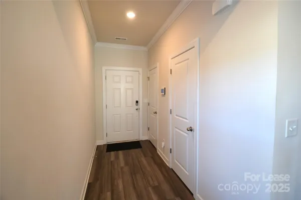 a view of a room with wooden floor