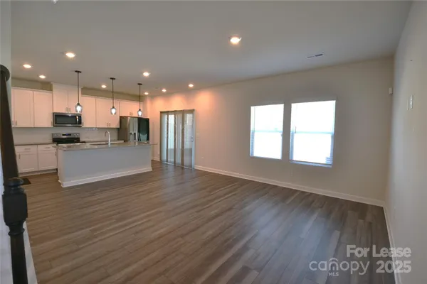 a view of kitchen with cabinets and wooden floor