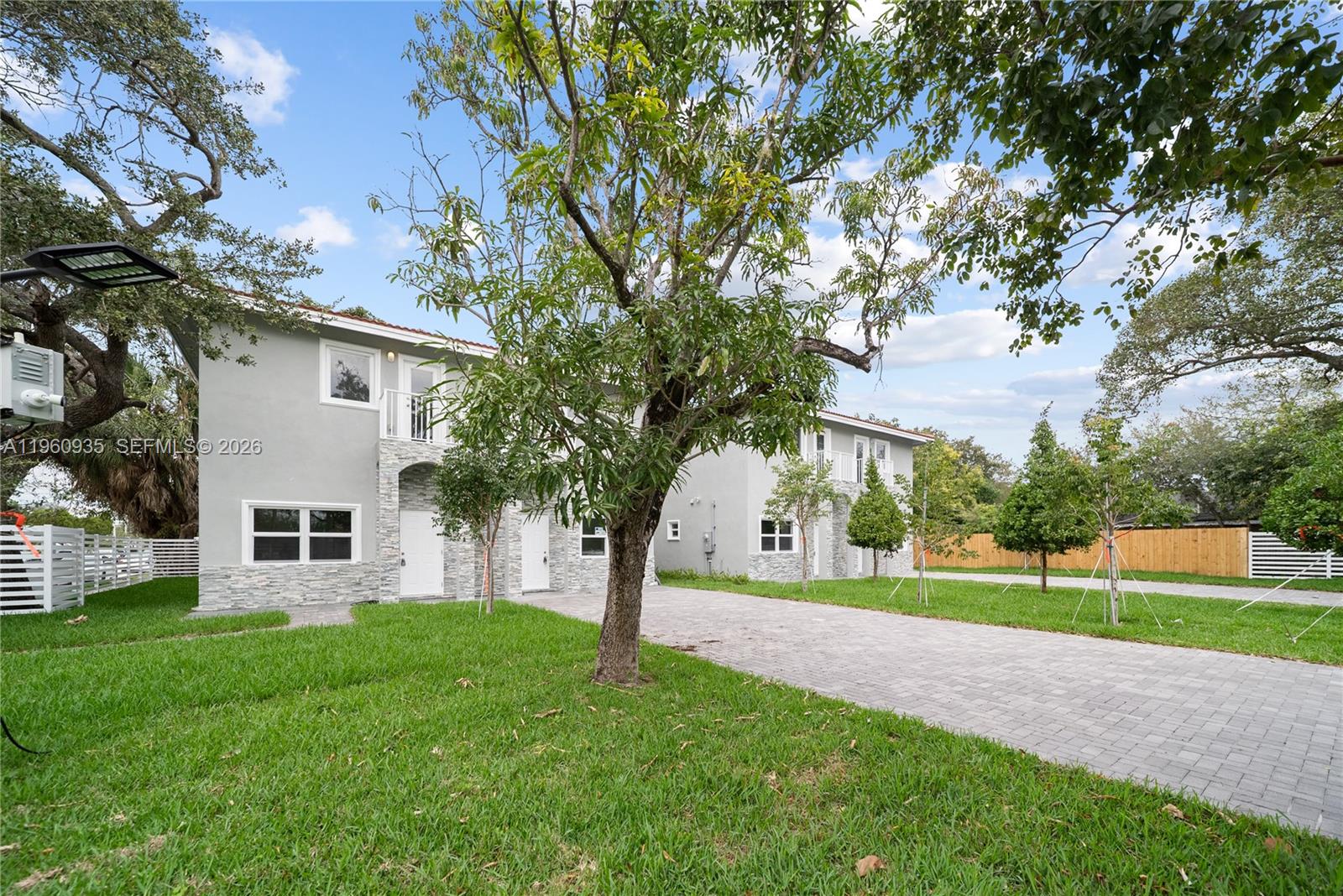 529 Northwest 56th Street Miami, FL 33127 - Photo 11 of 66 a view of a house with a tree in the background