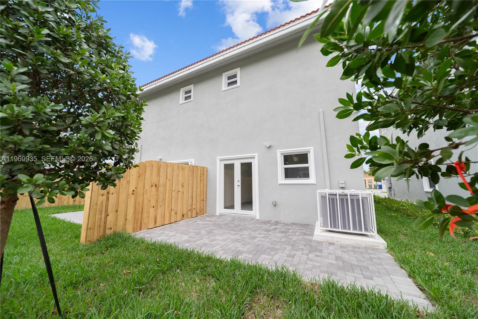 529 Northwest 56th Street Miami, FL 33127 - Photo 13 of 66 a front view of a house with a yard and garage