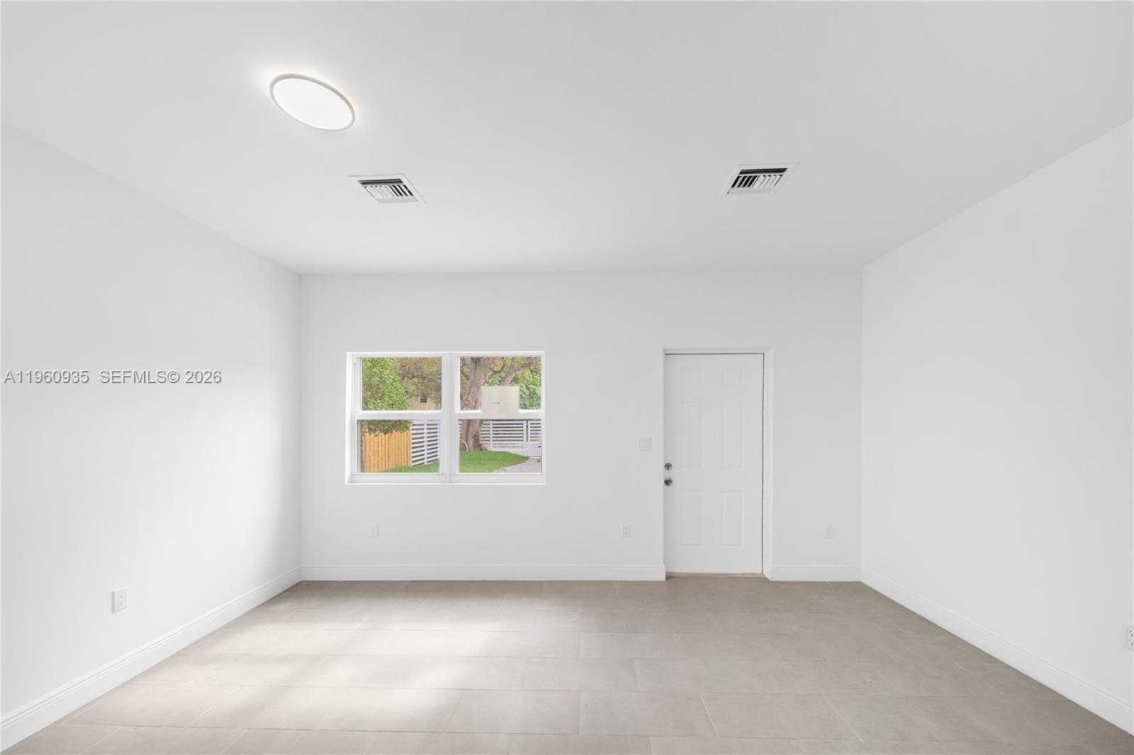 529 Northwest 56th Street Miami, FL 33127 - Photo 17 of 66 an empty room with windows