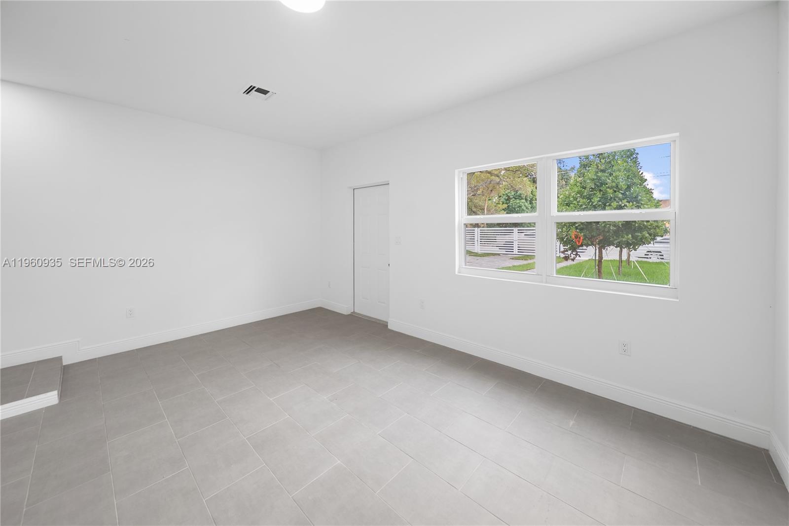 529 Northwest 56th Street Miami, FL 33127 - Photo 18 of 66 an empty room with a window